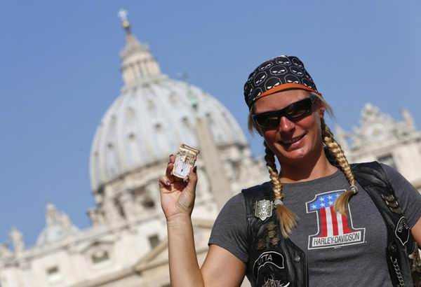 Woman with a Harley Davidson t-shirt holding cool stuff